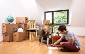 couple putting together furniture in living room
